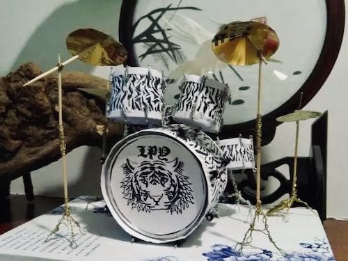 Georgia's crafting works: a semi-finished Jazz drum set, with a white tiger pattern on the bass drum